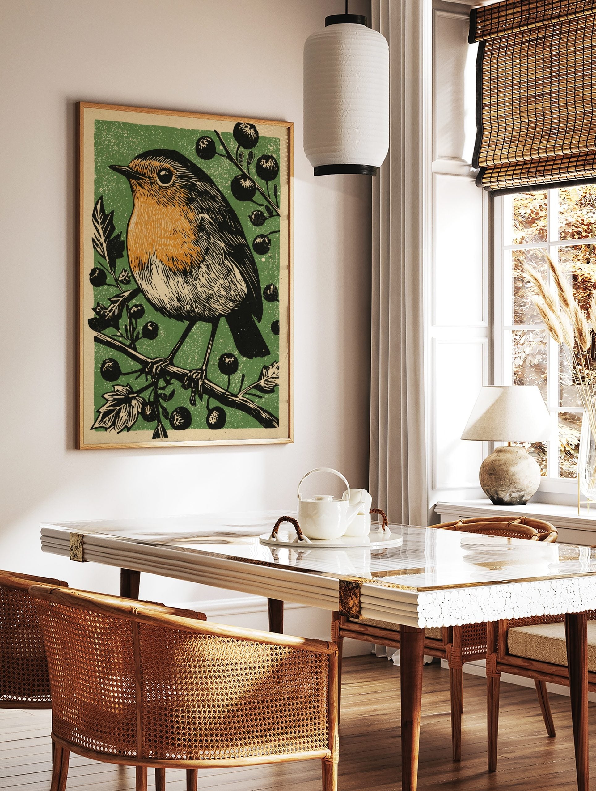 Linocut style illustration of a robin bird with orange breast on a berry branch, green background, in a styled room mockup