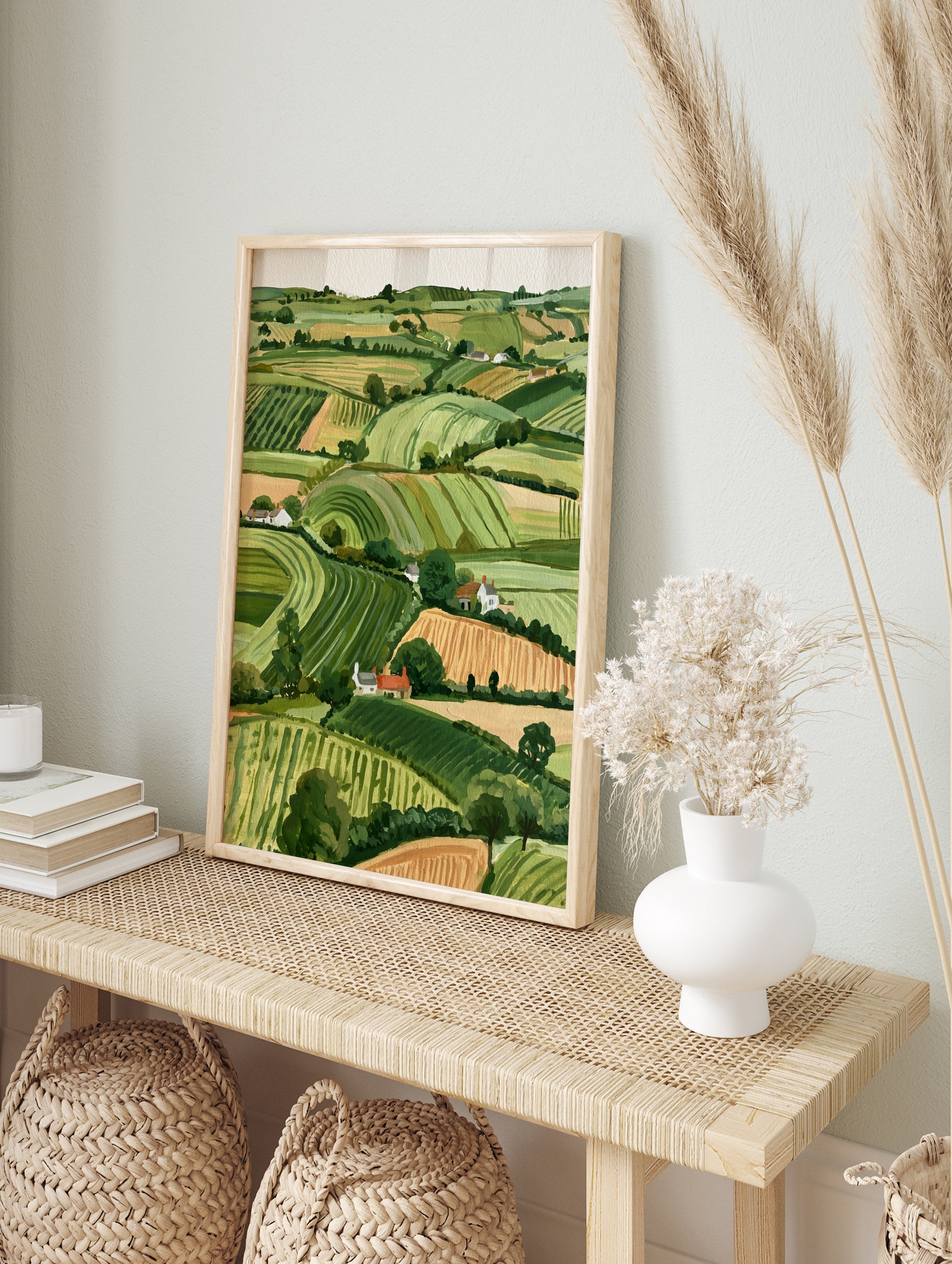 Rolling hills landscape with green fields and white cottages, illustrative countryside wall, in an alternate framed mockup