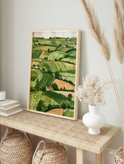 Rolling hills landscape with green fields and white cottages, illustrative countryside wall, in an alternate framed mockup