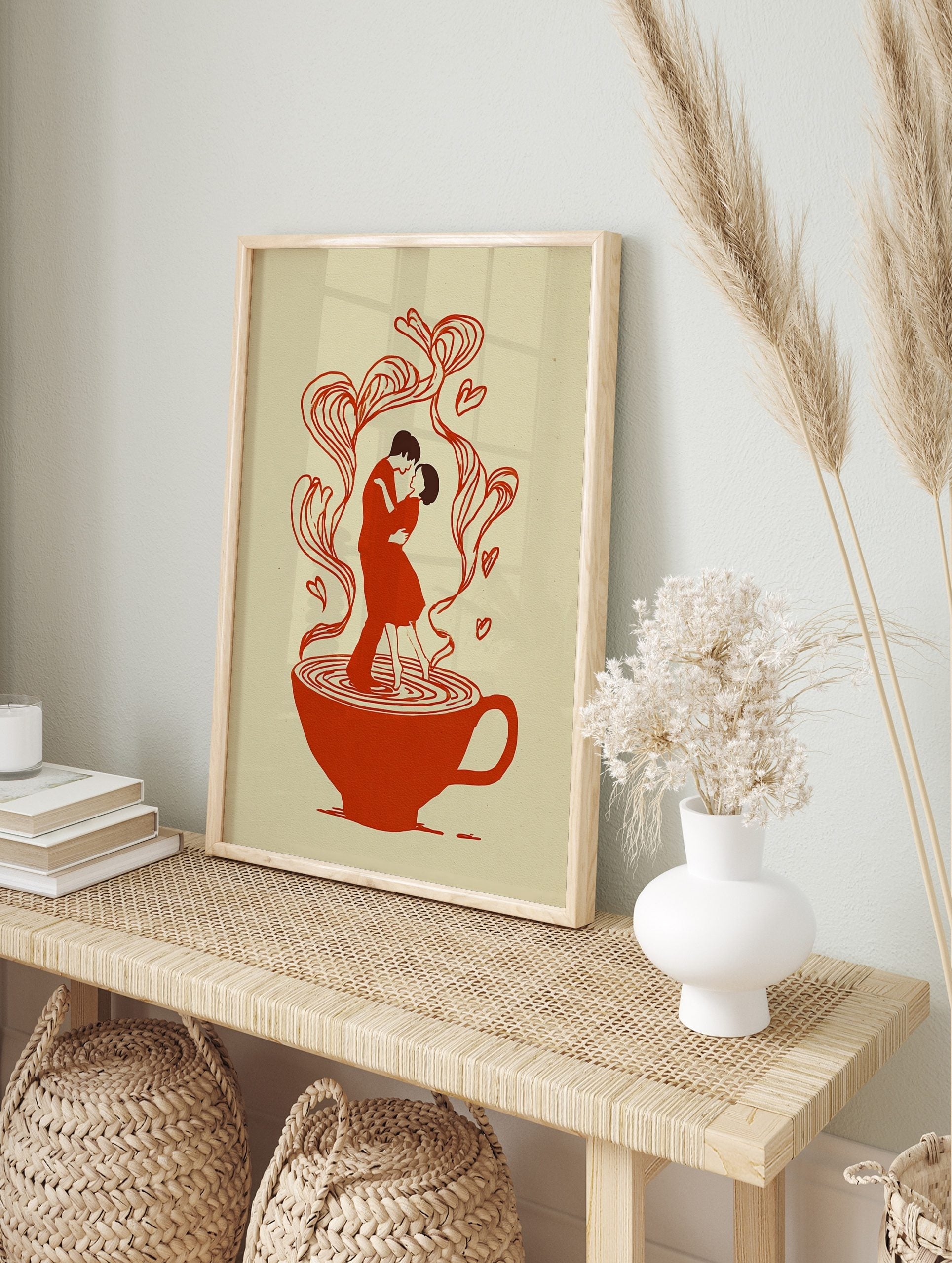 Illustrative art print of a couple dancing in a red teacup, with heart-shaped steam rising, in an alternate framed mockup