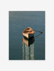 A wooden rowing boat floating on calm blue water with a detailed reflection, presented as a minimalist nautical art print