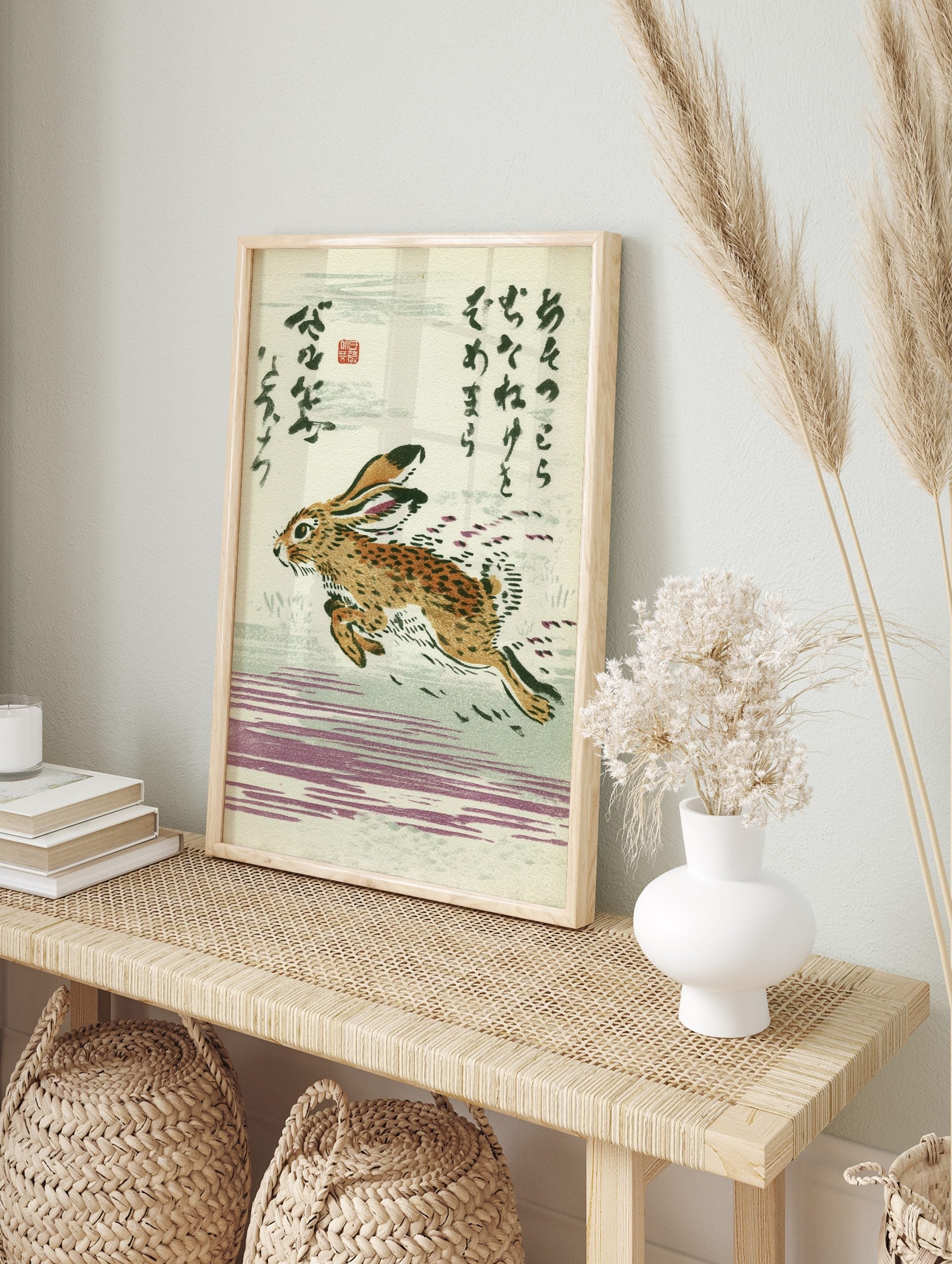 Japanese woodblock style print of a running brown hare with stylised movement and Kanji text, in an alternate framed mockup