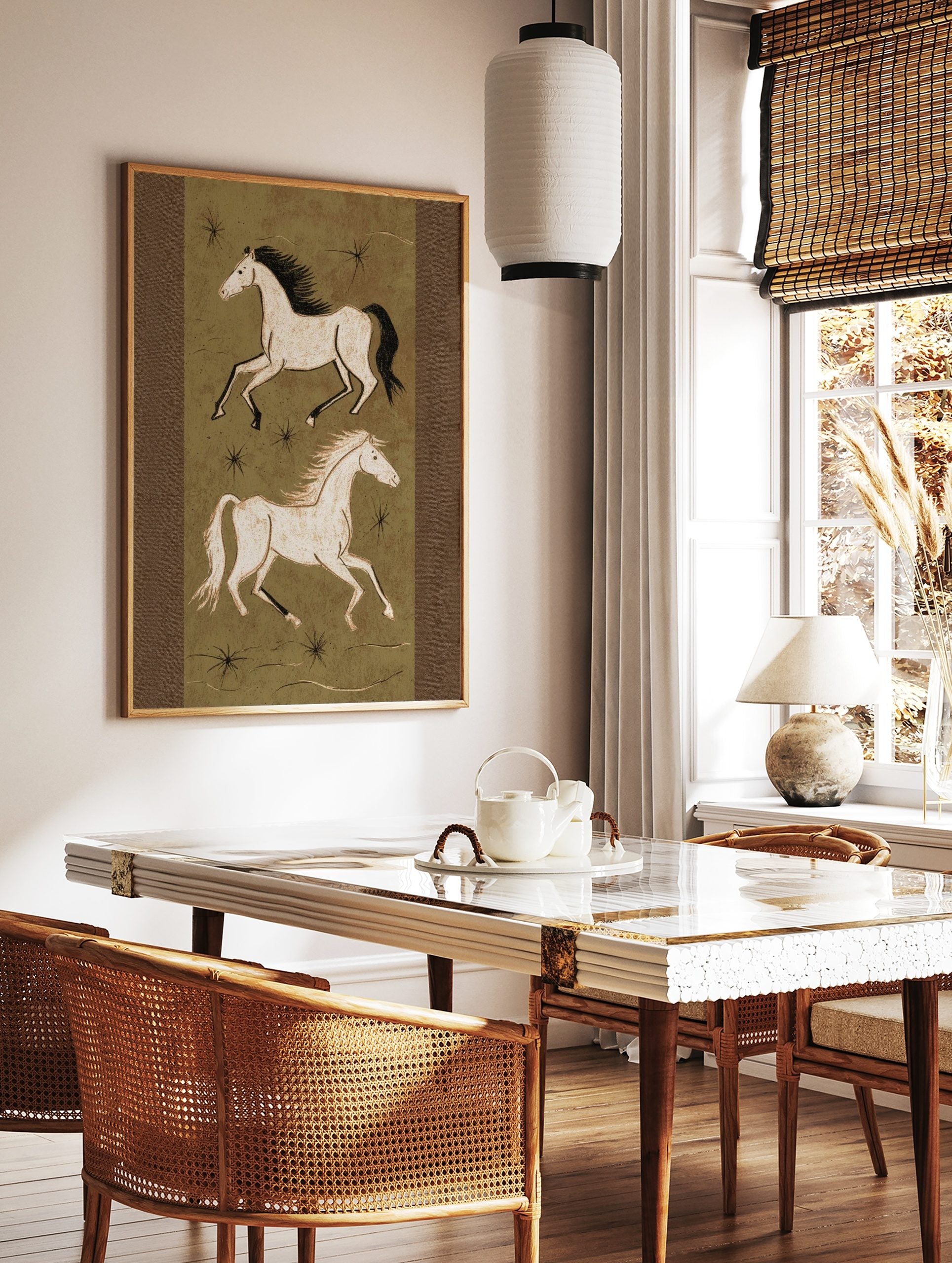 Illustrative art print of two running horses in off-white on an olive green background with black, in a styled room mockup