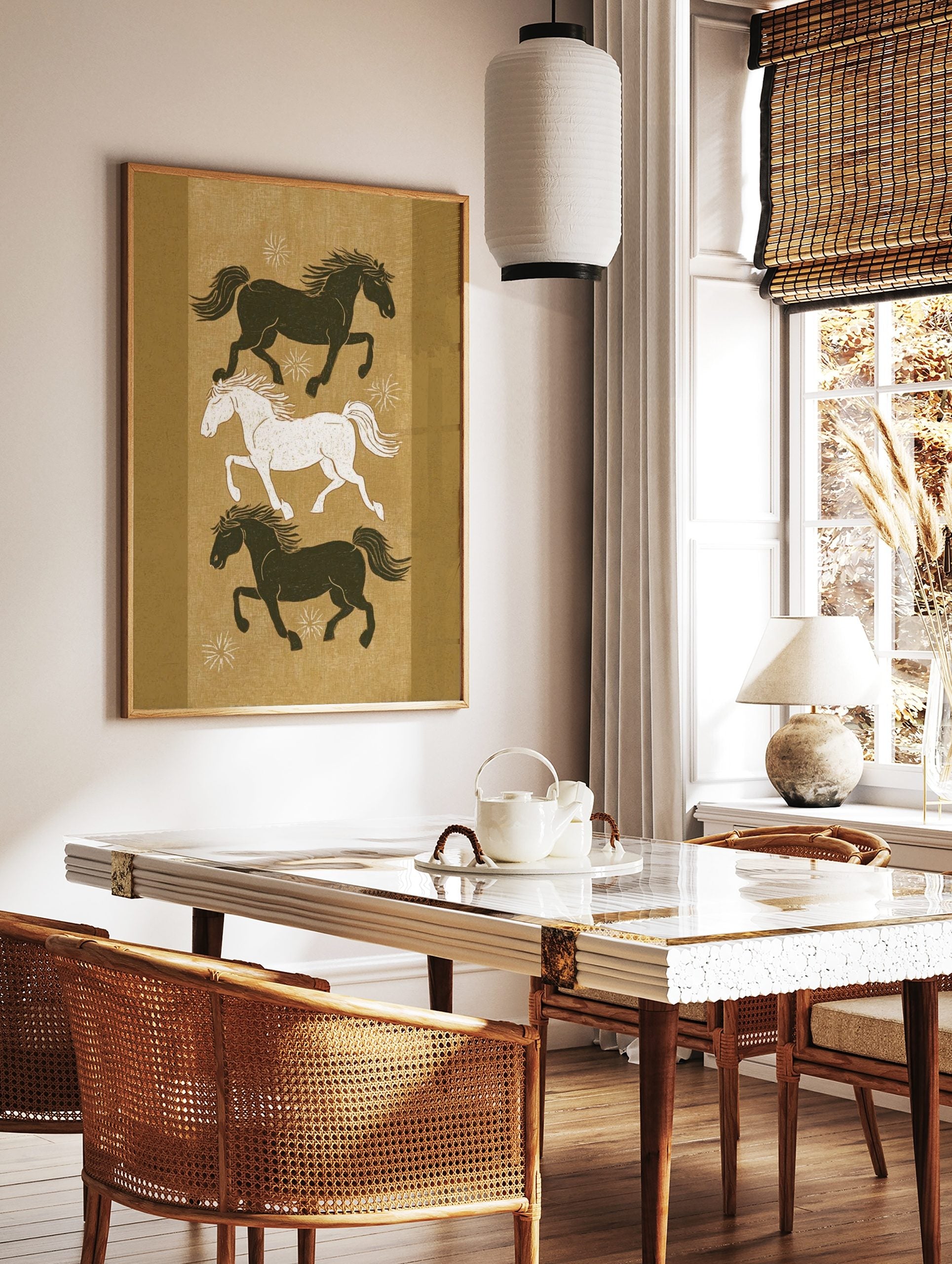 Three stylised running horses, two dark and one white, on an earthy golden-brown background with, in a styled room mockup