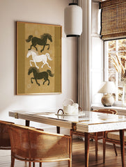 Three stylised running horses, two dark and one white, on an earthy golden-brown background with, in a styled room mockup