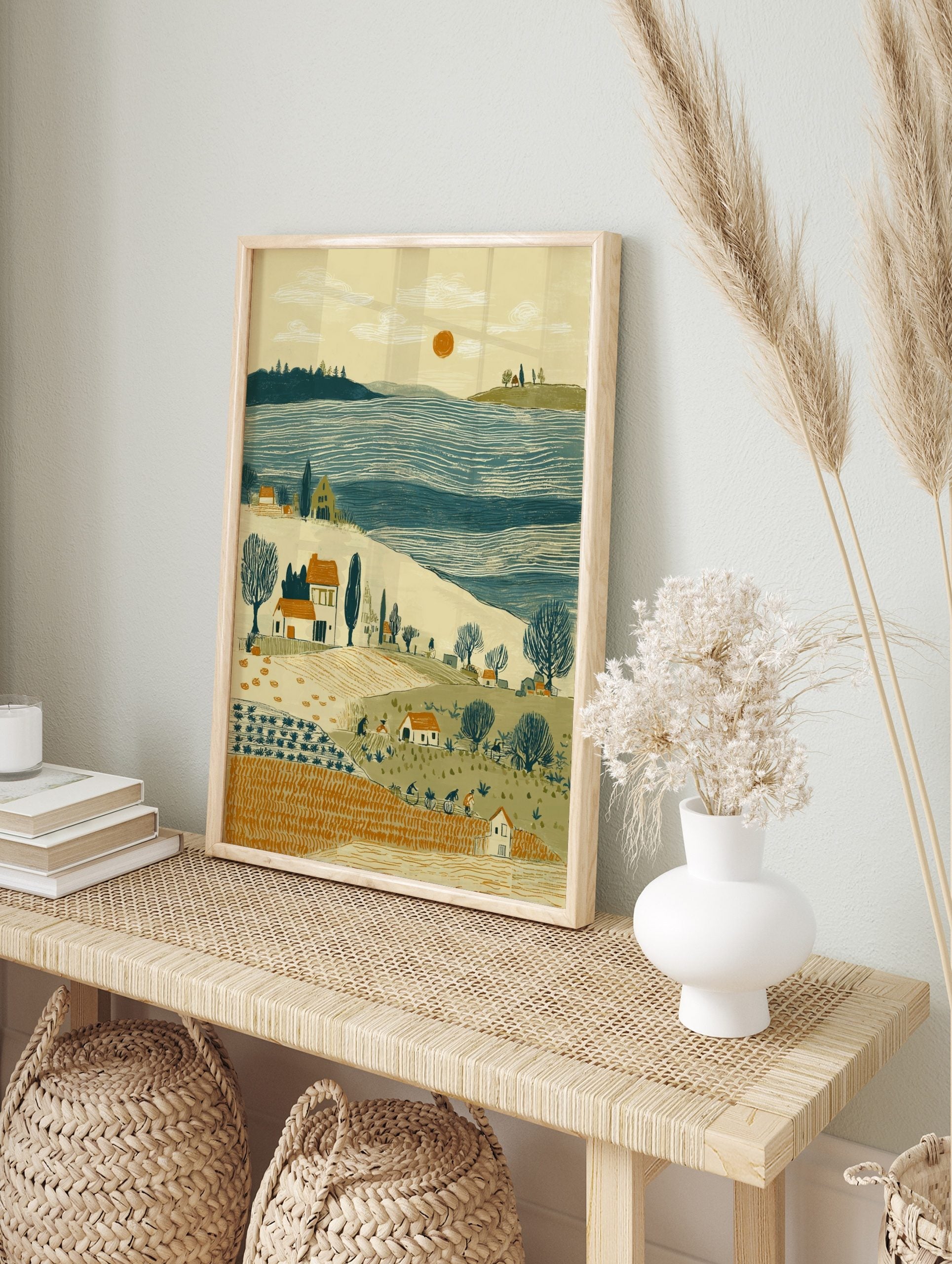 Rural harvest landscape print with farm workers, houses, bare trees, blue water, and orange, in an alternate framed mockup