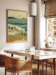 Rural harvest landscape print with farm workers, houses, bare trees, blue water, and orange sun in, in a styled room mockup