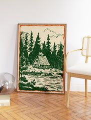 Rustic cabin wall art print showing a vintage illustration of a cabin by a forest lake with pine trees and mountains. - Image 2