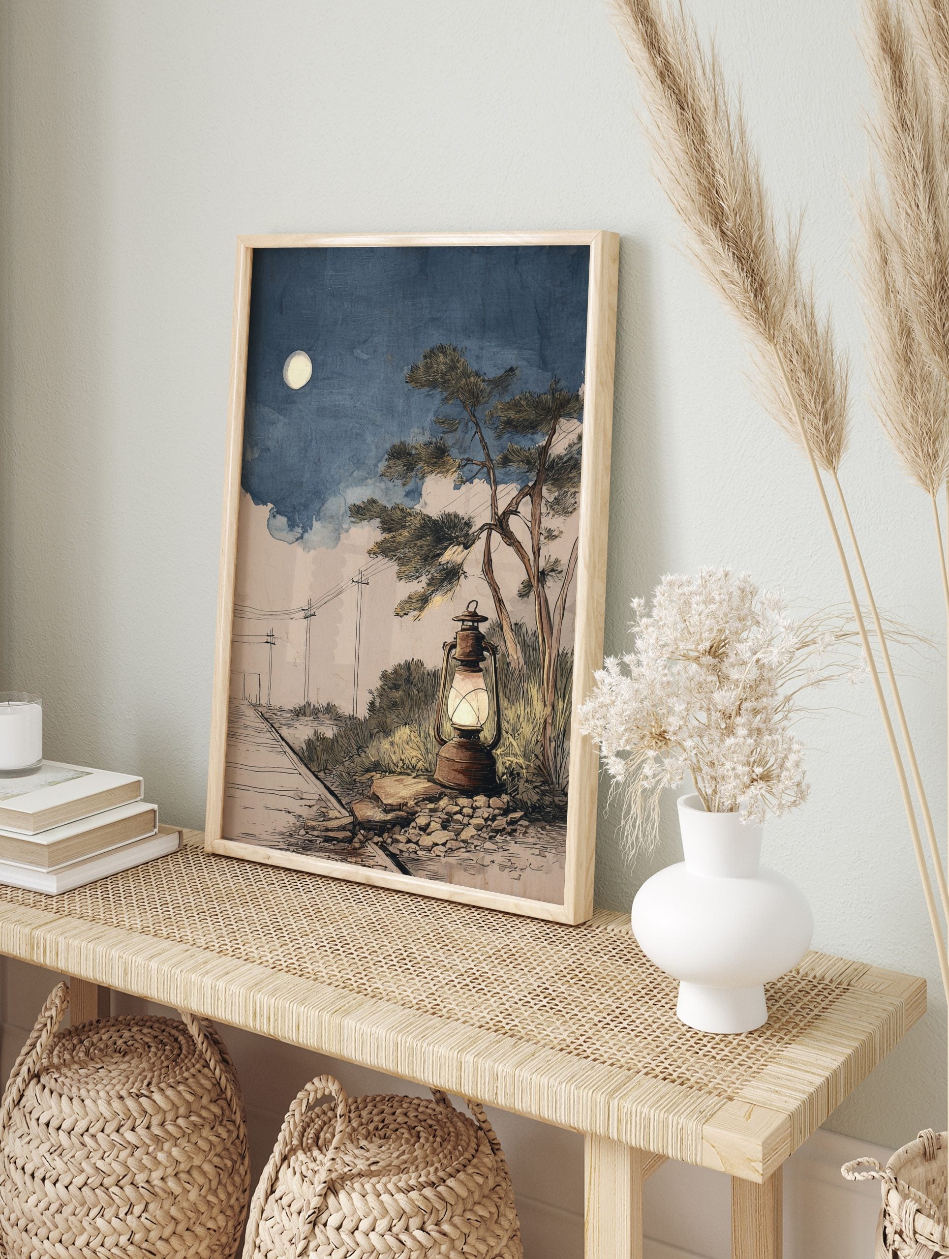 Illustrative rustic lantern glowing by railway tracks under a full moon in a blue night sky, in an alternate framed mockup