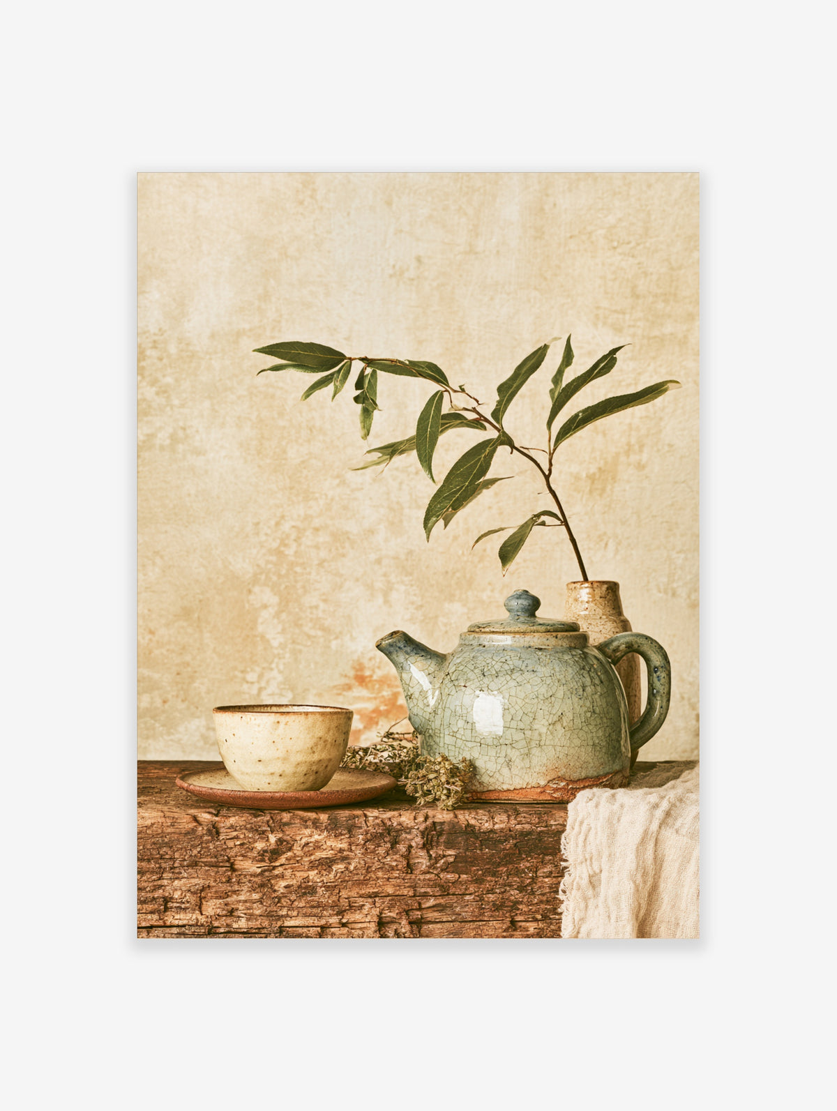 Rustic still life poster with crackle-glaze teapot, ceramic cup, and green sprig on weathered wood