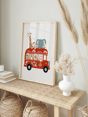 Illustrative wall art of safari animals on a red double-decker bus, featuring a giraffe, in an alternate framed mockup