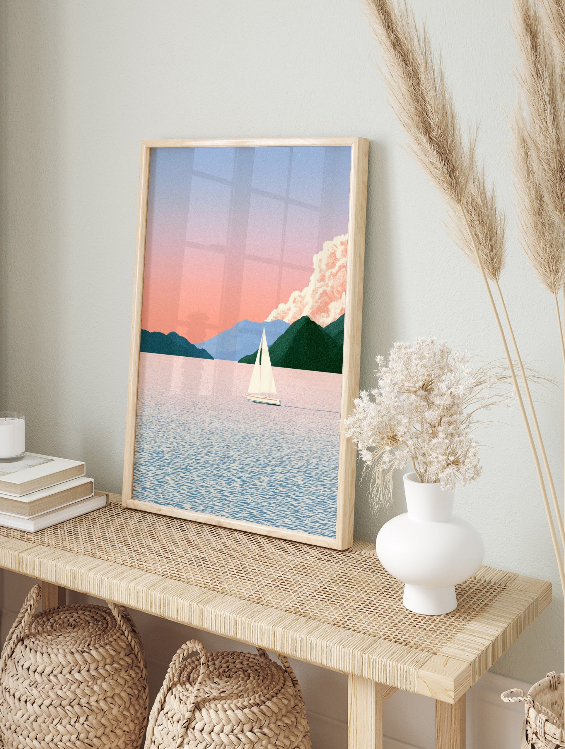 Minimalist sailboat on calm water with mountain background in pastel pink and green tones, in an alternate framed mockup