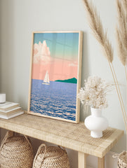 Illustration of a sailboat on blue water with a distant green headland under a soft pink, in an alternate framed mockup