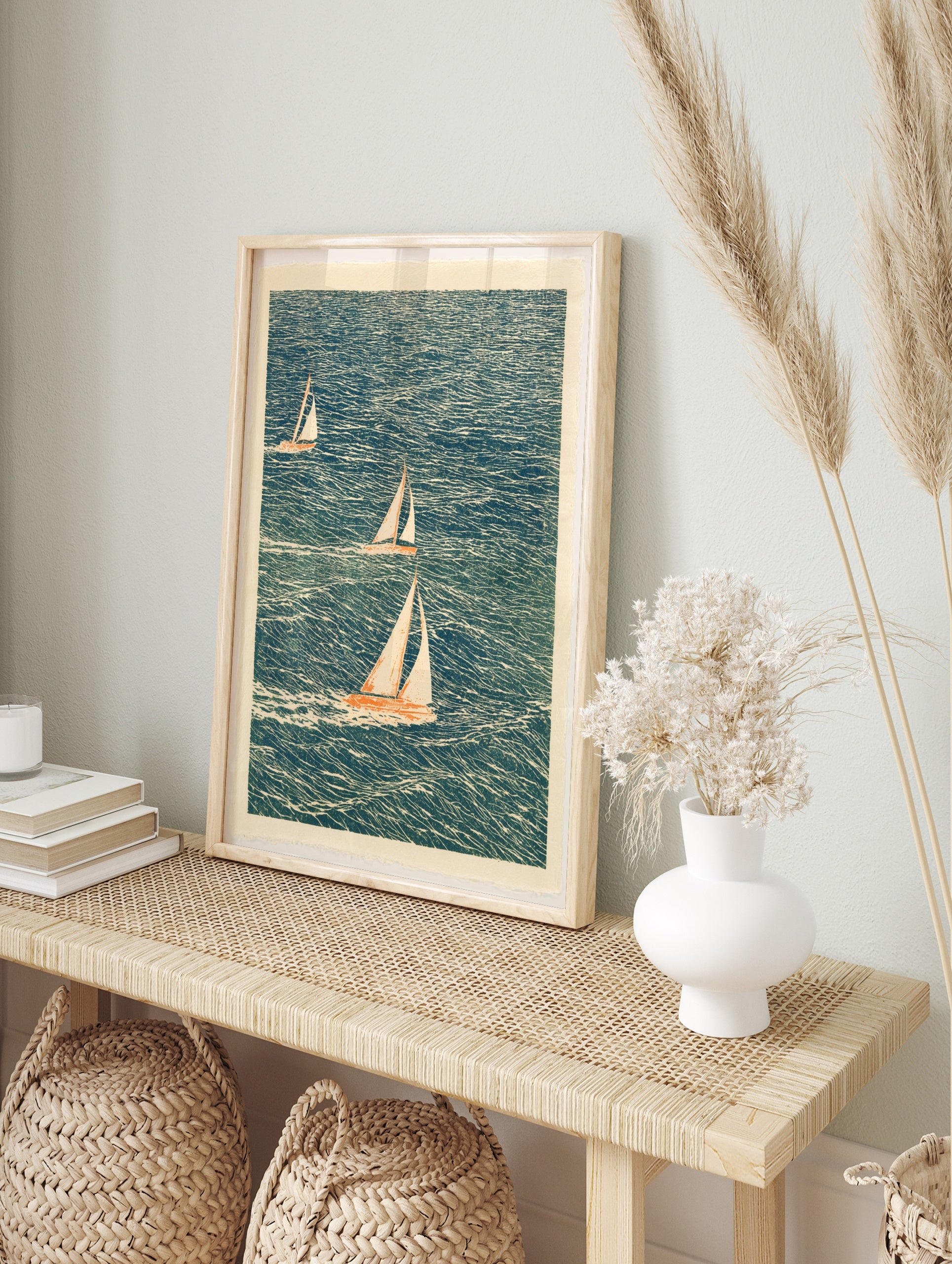 Illustrative sailboat wall art with three boats on a textured blue sea, cream sails, nautical, in an alternate framed mockup