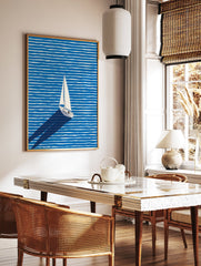 White sailboat with a long shadow sailing across a blue and white striped ocean in a modern illustration wall art. - Image 2