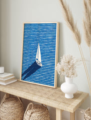 White sailboat with a long shadow sailing across a blue and white striped ocean in a modern illustration wall art. - Image 3