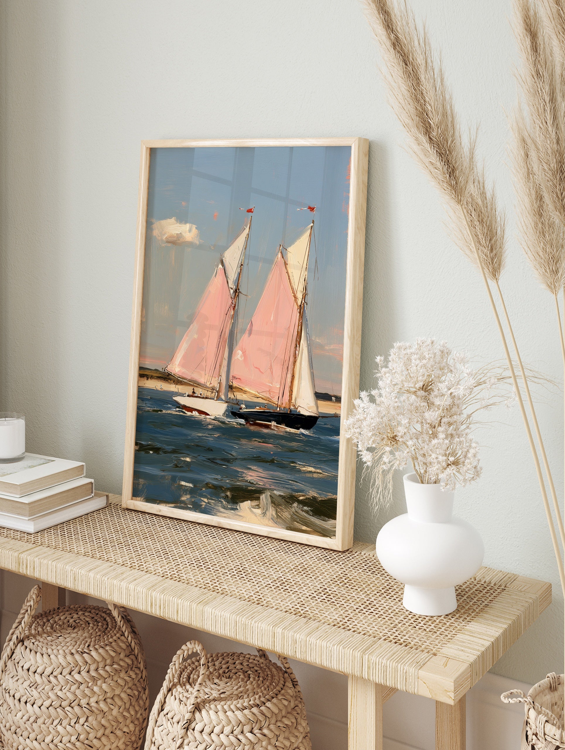 Painterly art print of two sailboats with pink sails on blue water, coastal nautical scene, in an alternate framed mockup
