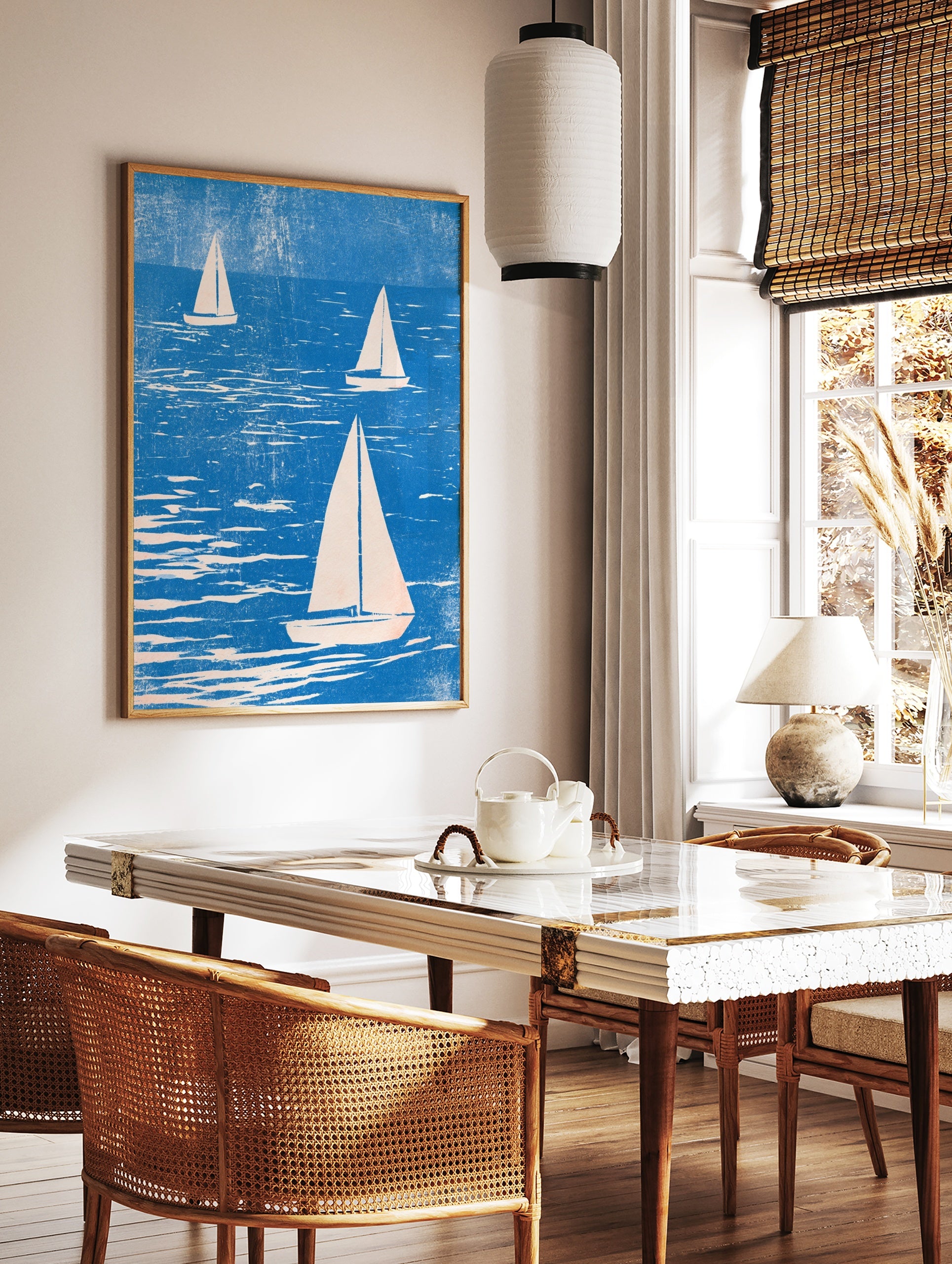 Three sailboats on textured blue water, illustrative style nautical wall art print with cream sails, in a styled room mockup