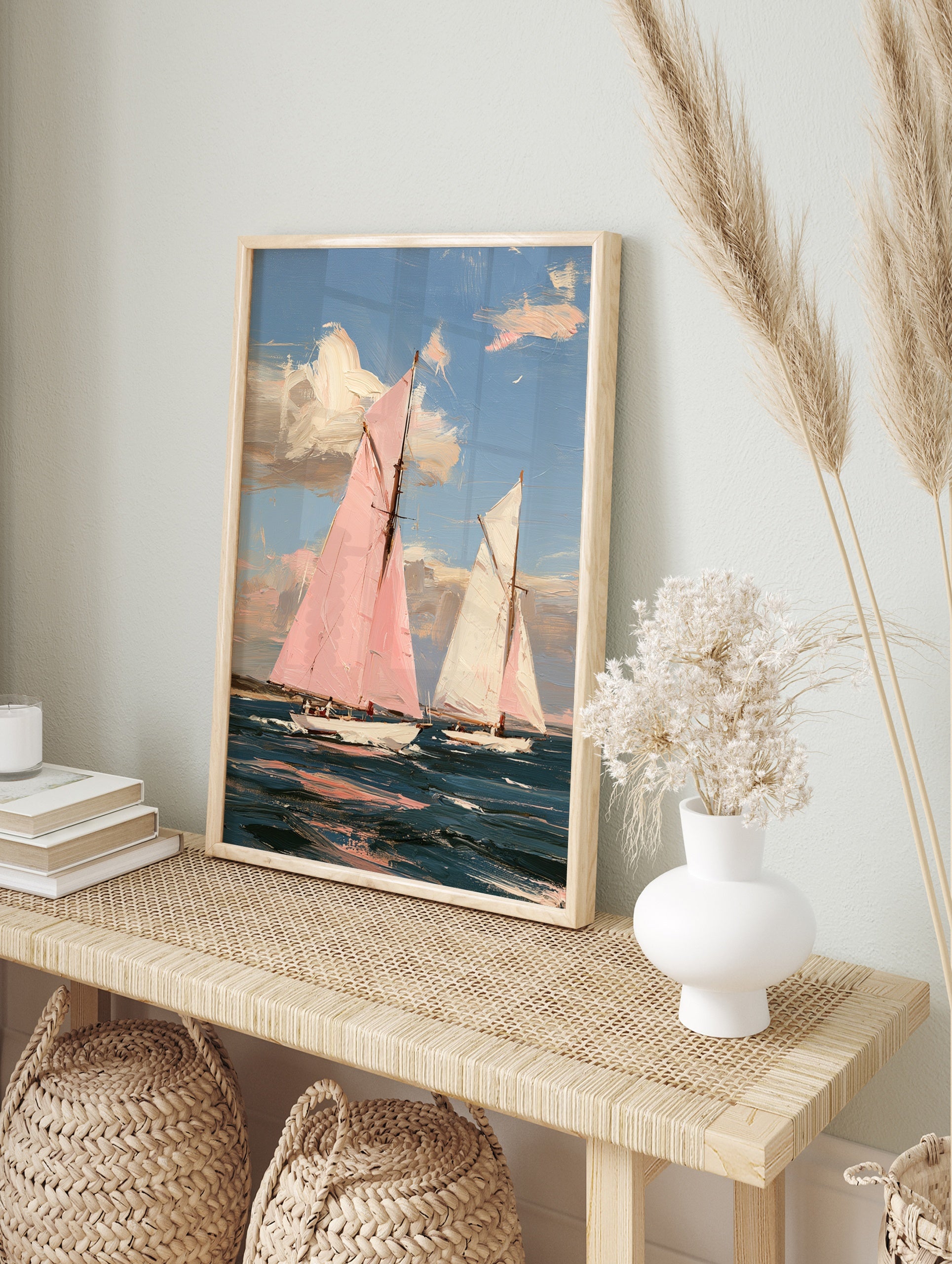Impressionist painting of two sailboats, one with a pink sail, on a blue sea under a sky with, in an alternate framed mockup