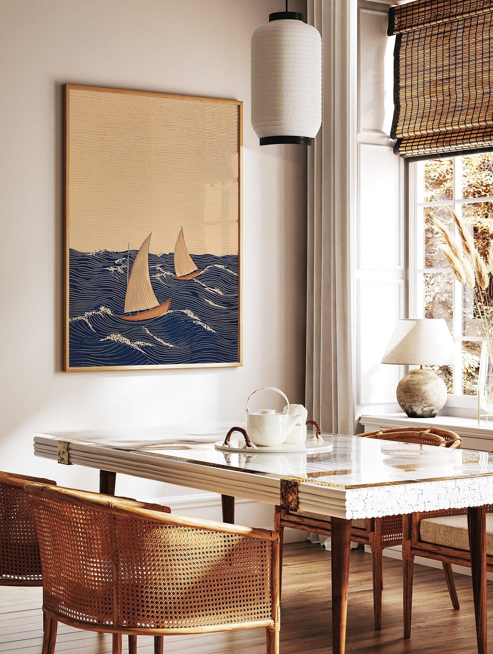 Illustrative print of two sailboats with beige sails and reddish hulls on a dark blue wavy sea with, in a styled room mockup