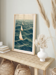 Four sailing boats with white sails and orange hulls on a deep blue sea in an illustrative, in an alternate framed mockup