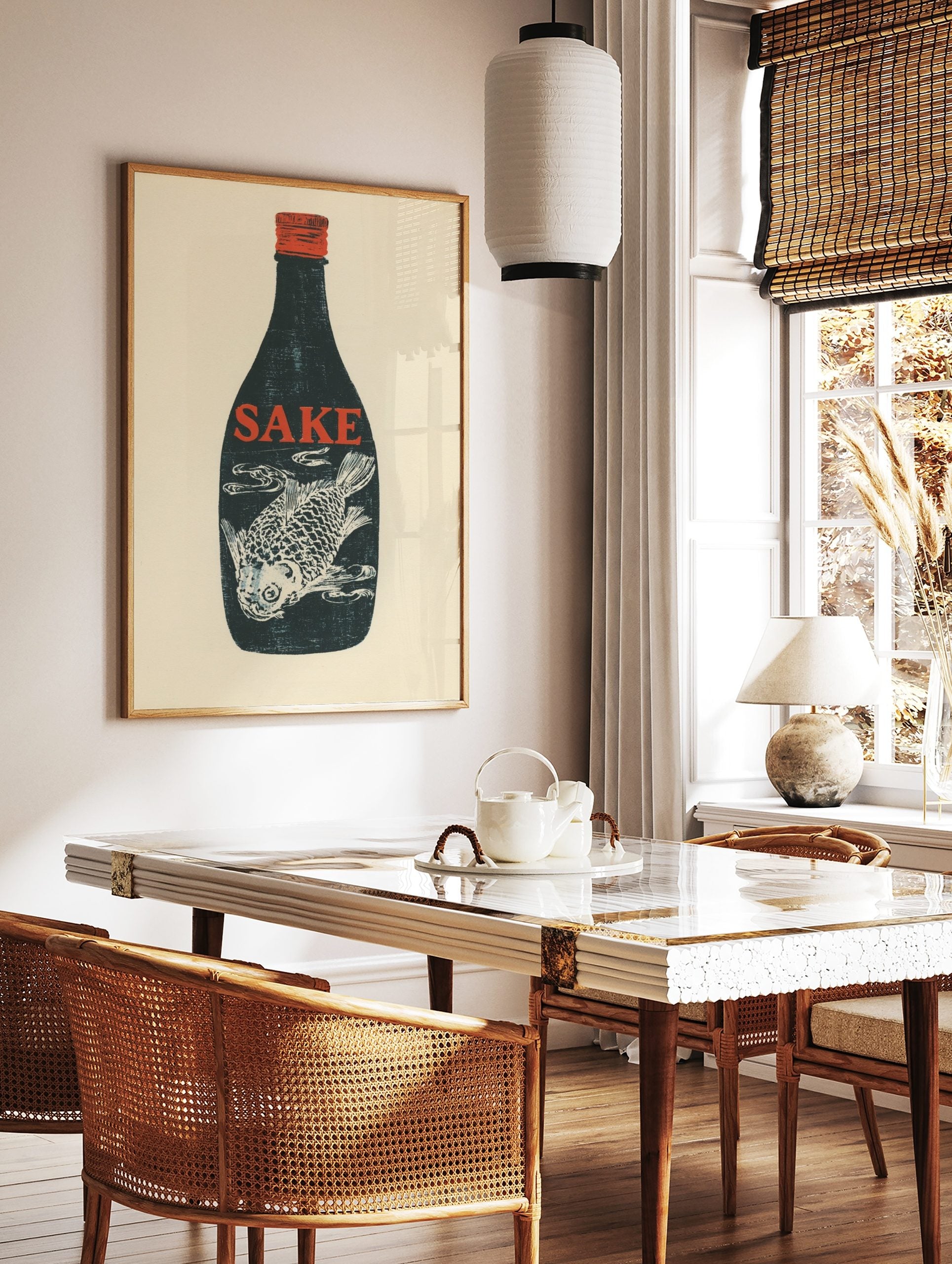 Dark blue sake bottle with red 'SAKE' text and white fish illustration inside, red cap, cream, in a styled room mockup