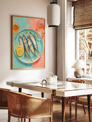 Illustrative wall art of four whole sardines with lemon and herbs on a blue plate, with glasses, in a styled room mockup