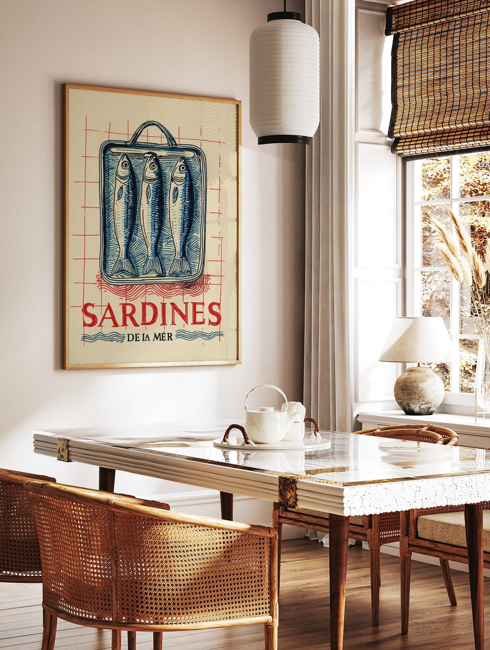 Vintage-style illustration of three blue sardines in a tin can with red 'SARDINES DE LA MÈR' text, in a styled room mockup