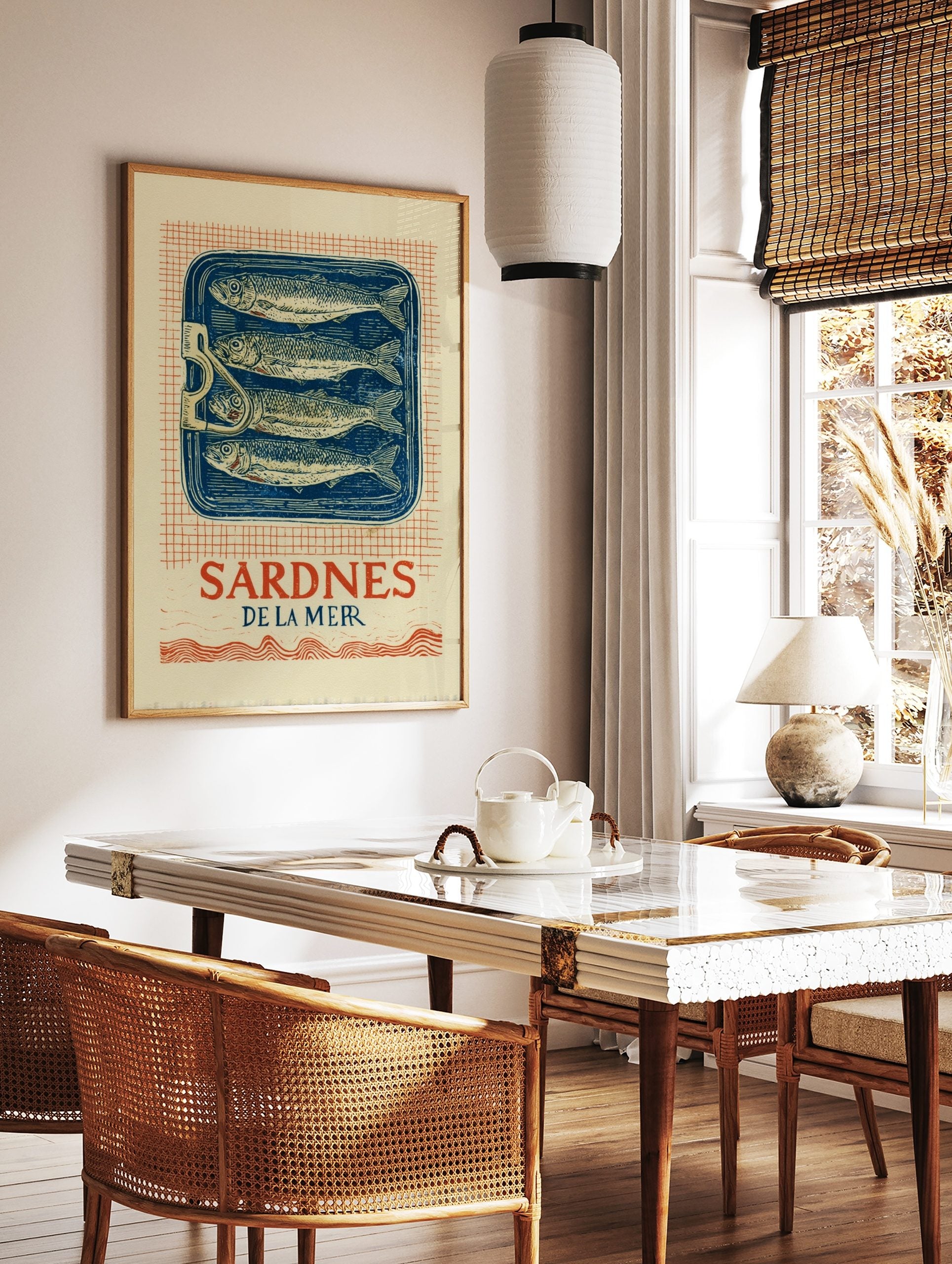 Vintage Sardines De La Mer wall art print with four fish in a blue tin, red grid background, and, in a styled room mockup