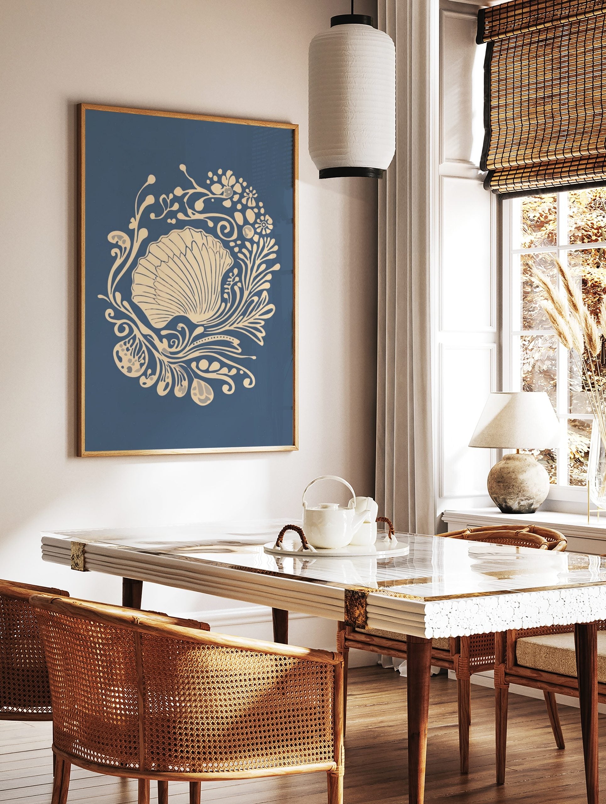 Ornate scallop shell illustration with beige botanical swirls on a deep blue background, in a styled room mockup