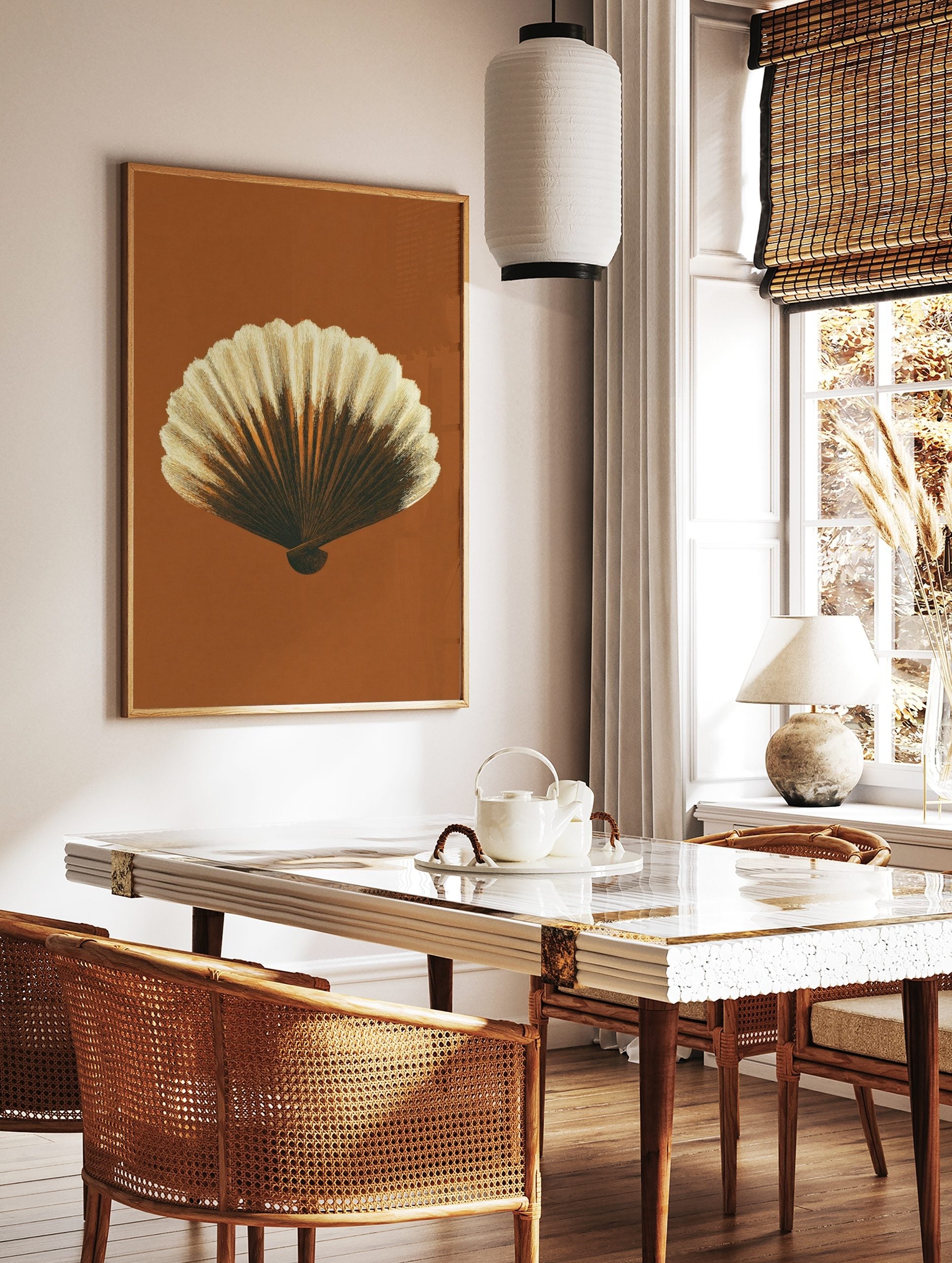 Detailed illustrative print of a scallop shell in brown and cream tones against a rust background, in a styled room mockup