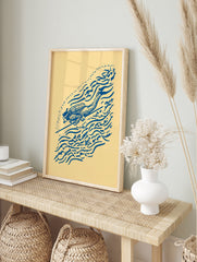Blue illustrative scuba diver print with speargun, fish, and bubble motifs on a cream, in an alternate framed mockup