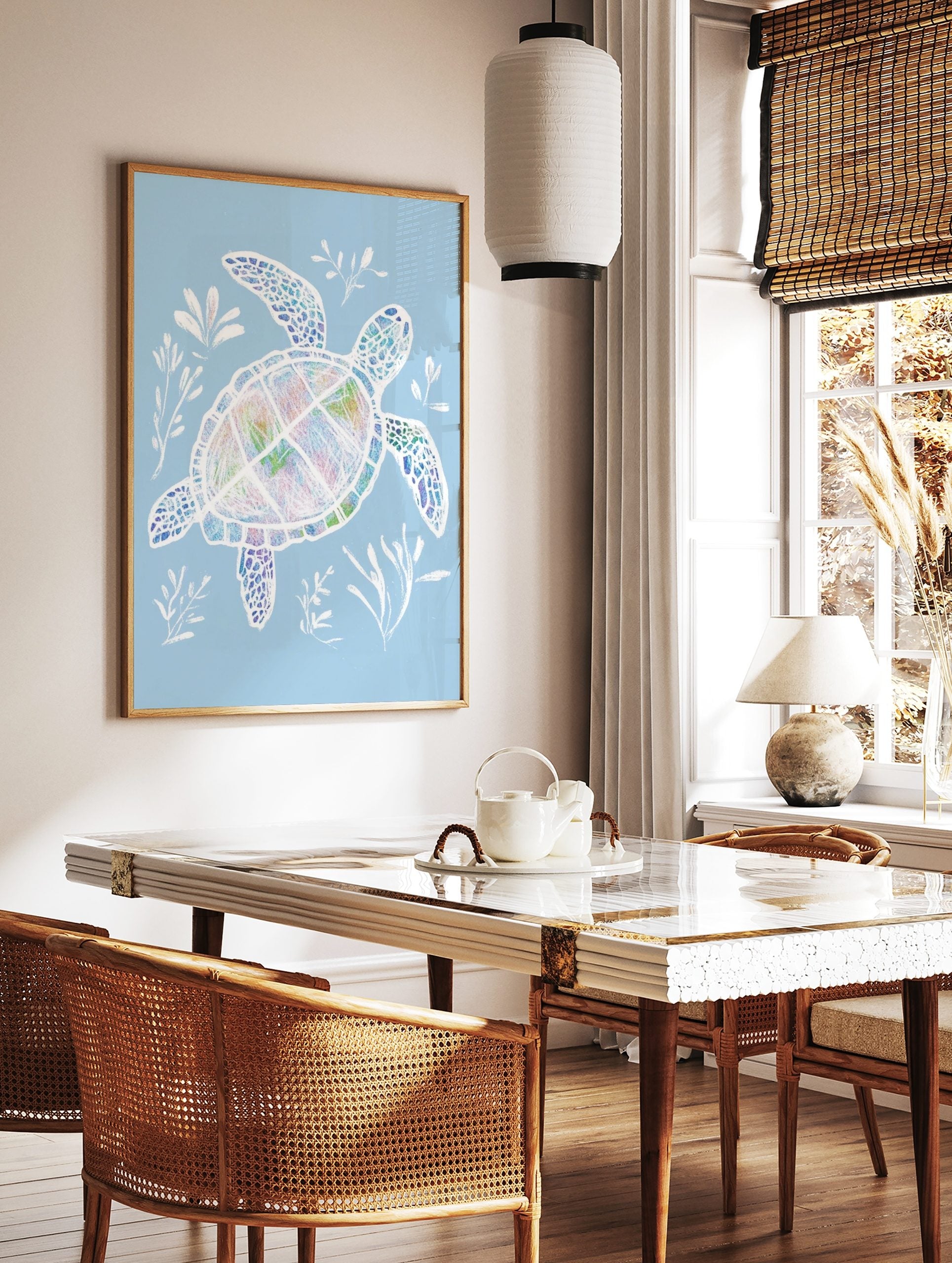 Colourful sea turtle illustration with white outlines, swimming with white seaweed on a pale blue, in a styled room mockup