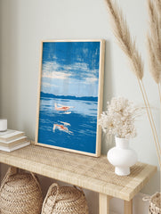 Illustrative seaplane wall art print flying over blue water with mountain background, in an alternate framed mockup