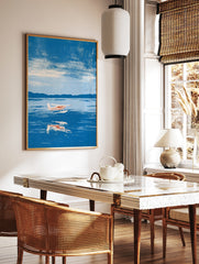 Illustrative seaplane wall art print flying over blue water with mountain background, in a styled room mockup