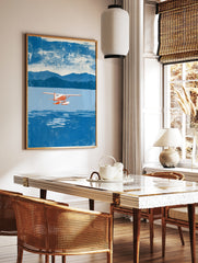Red and white seaplane flying over blue water with mountains in the background, illustrative style, in a styled room mockup