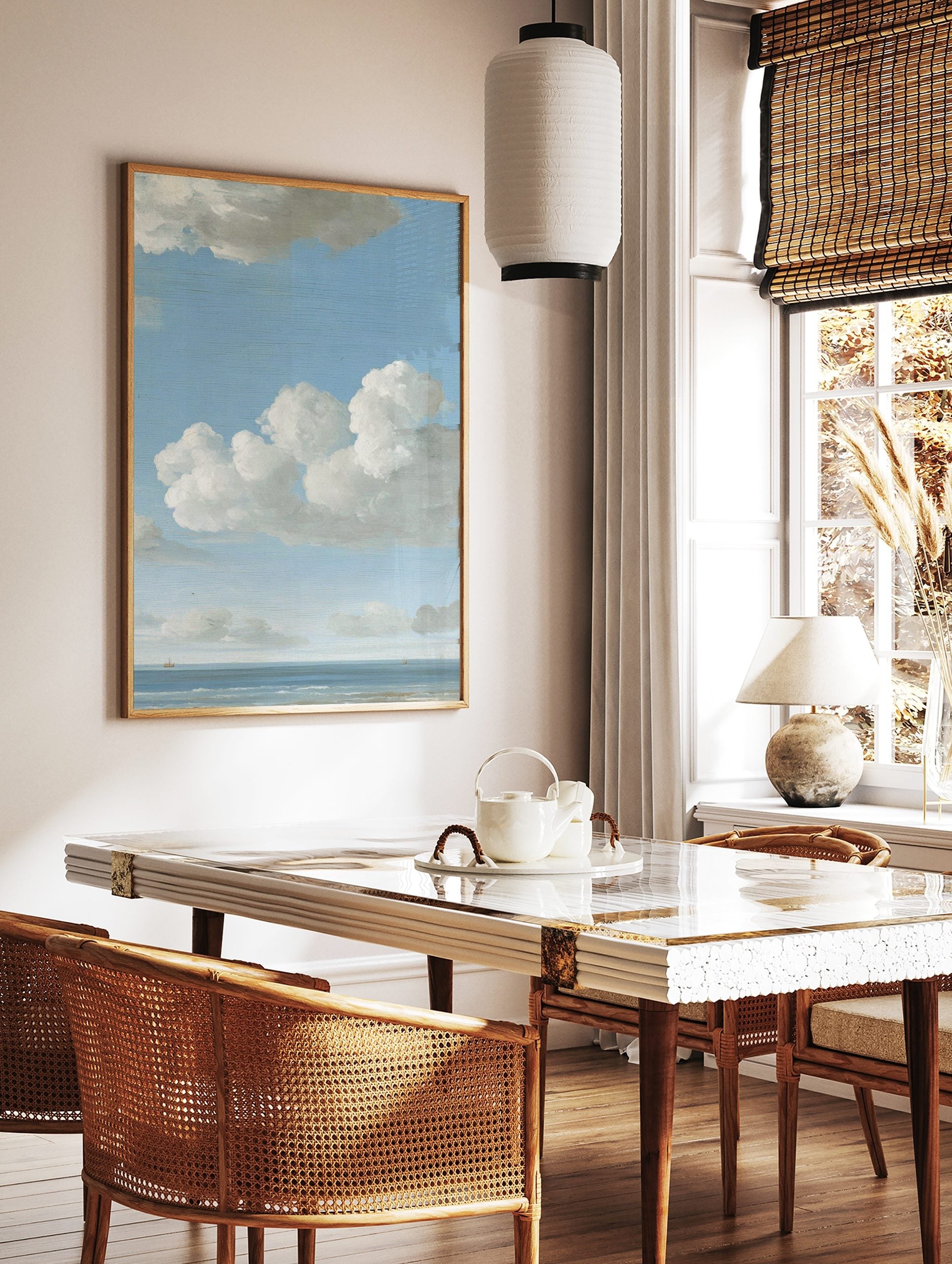 Seascape painting with blue sky, white cumulus clouds, calm ocean, and two small distant boats on, in a styled room mockup