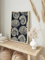 Stylised navy and cream ammonite seashell pattern illustration, repeating spiral shells, in an alternate framed mockup