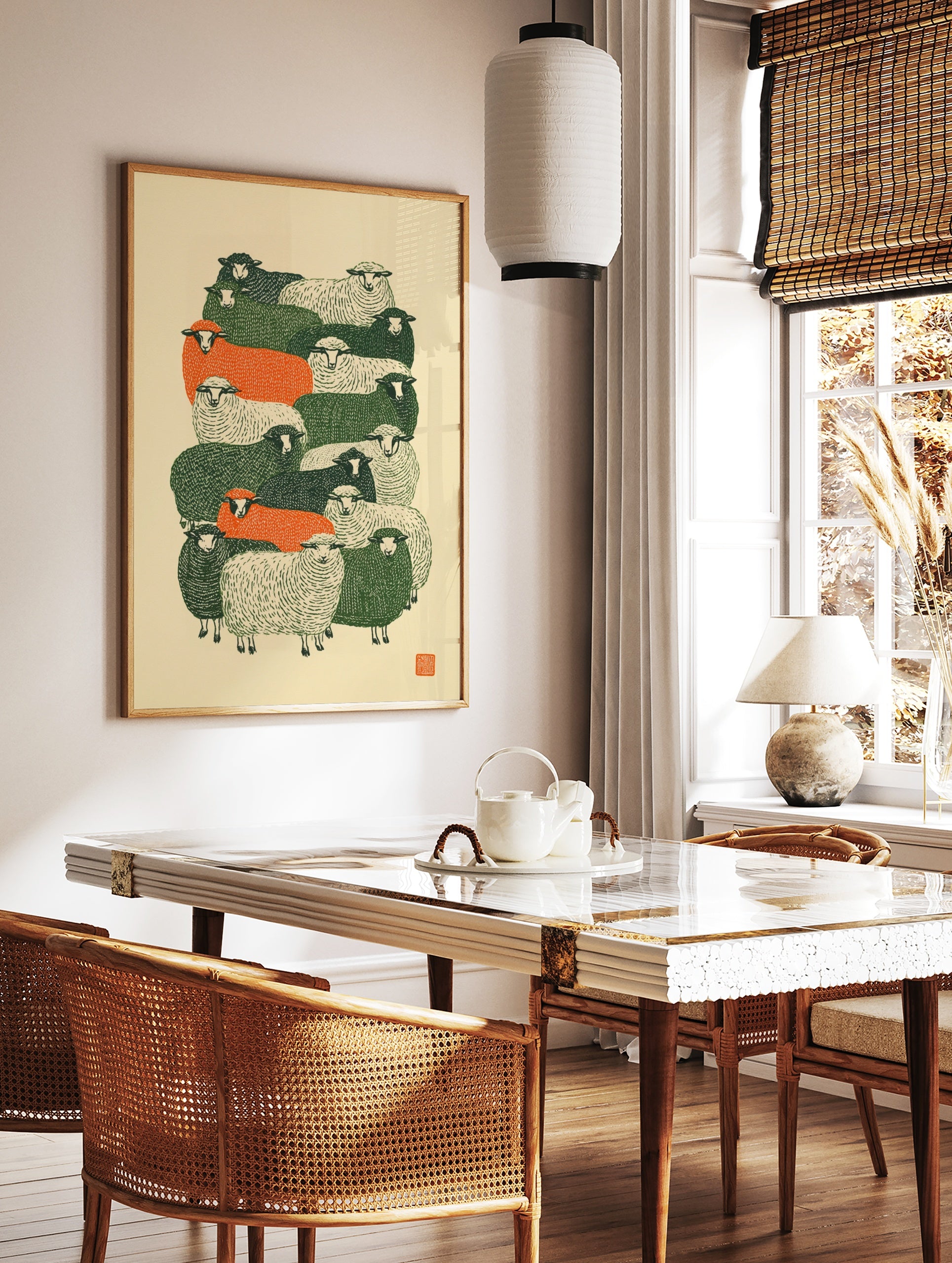 Stylised flock of sheep in green, orange, and cream colours, graphic linocut-inspired art print on, in a styled room mockup