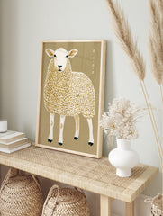 Illustrative sheep wall art with Japanese typography on a tan background, in an alternate framed mockup