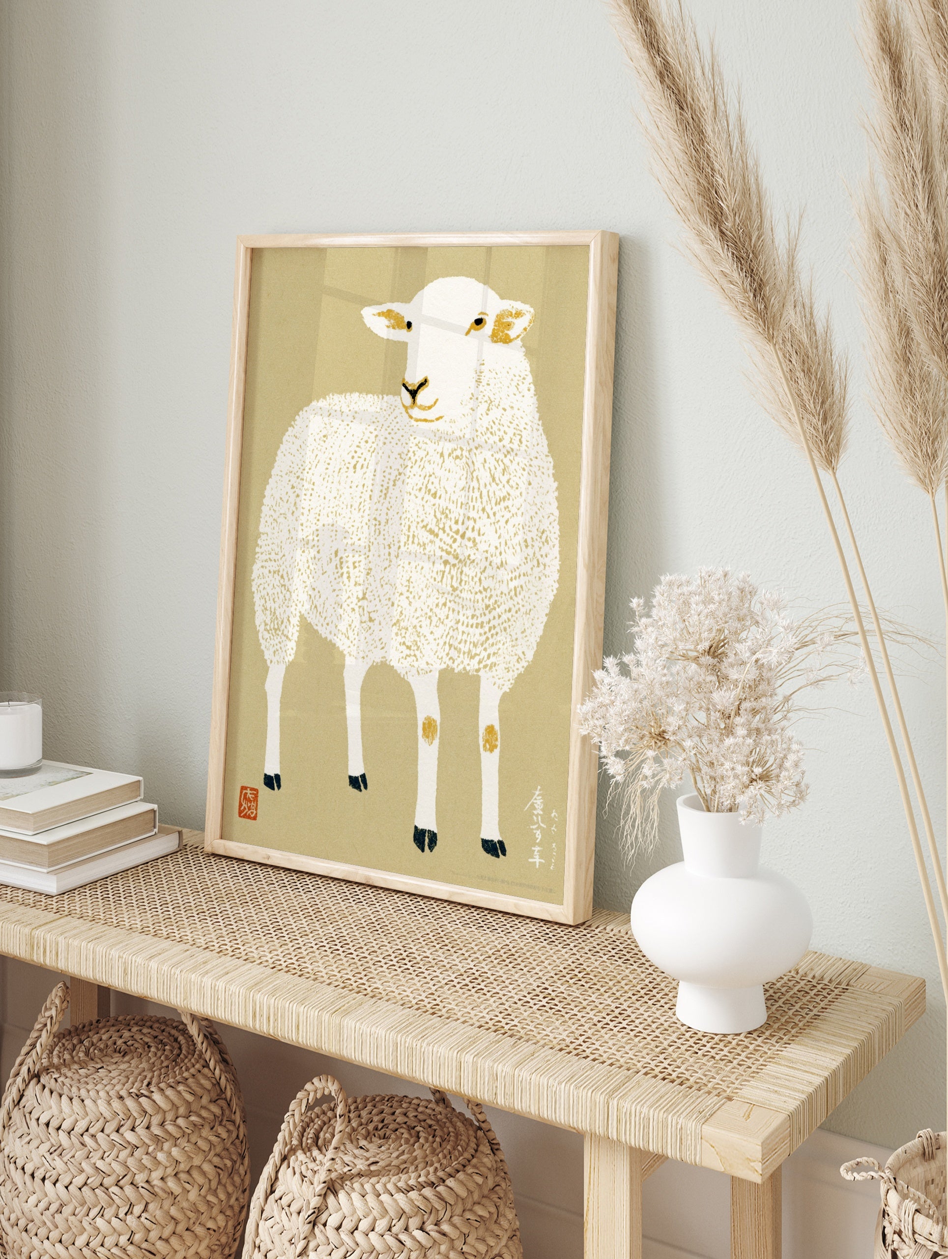 Illustrative sheep print with textured wool, Japanese calligraphy, and gold accents on a, in an alternate framed mockup