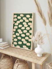 Illustrative sheep pattern art print with cream-coloured sheep on a solid dark green, in an alternate framed mockup