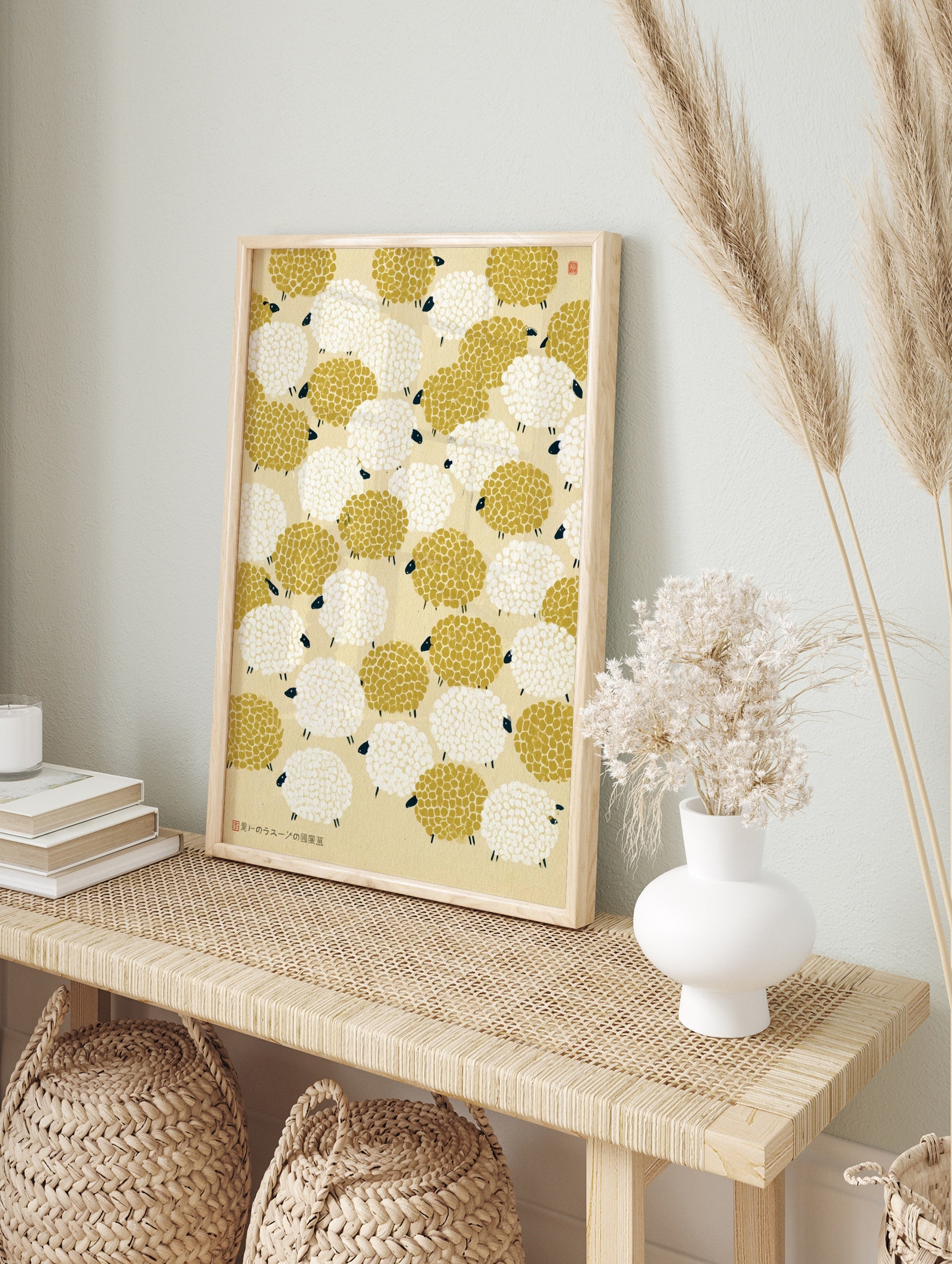 Repeating pattern of mustard yellow and white sheep with black faces on a cream background, in an alternate framed mockup