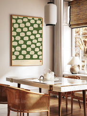 Illustrative pattern of white fluffy sheep on a green background with a red artist seal at the, in a styled room mockup