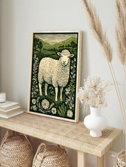 Linocut style print of a fluffy sheep in a field with wildflowers and green hills, green and, in an alternate framed mockup