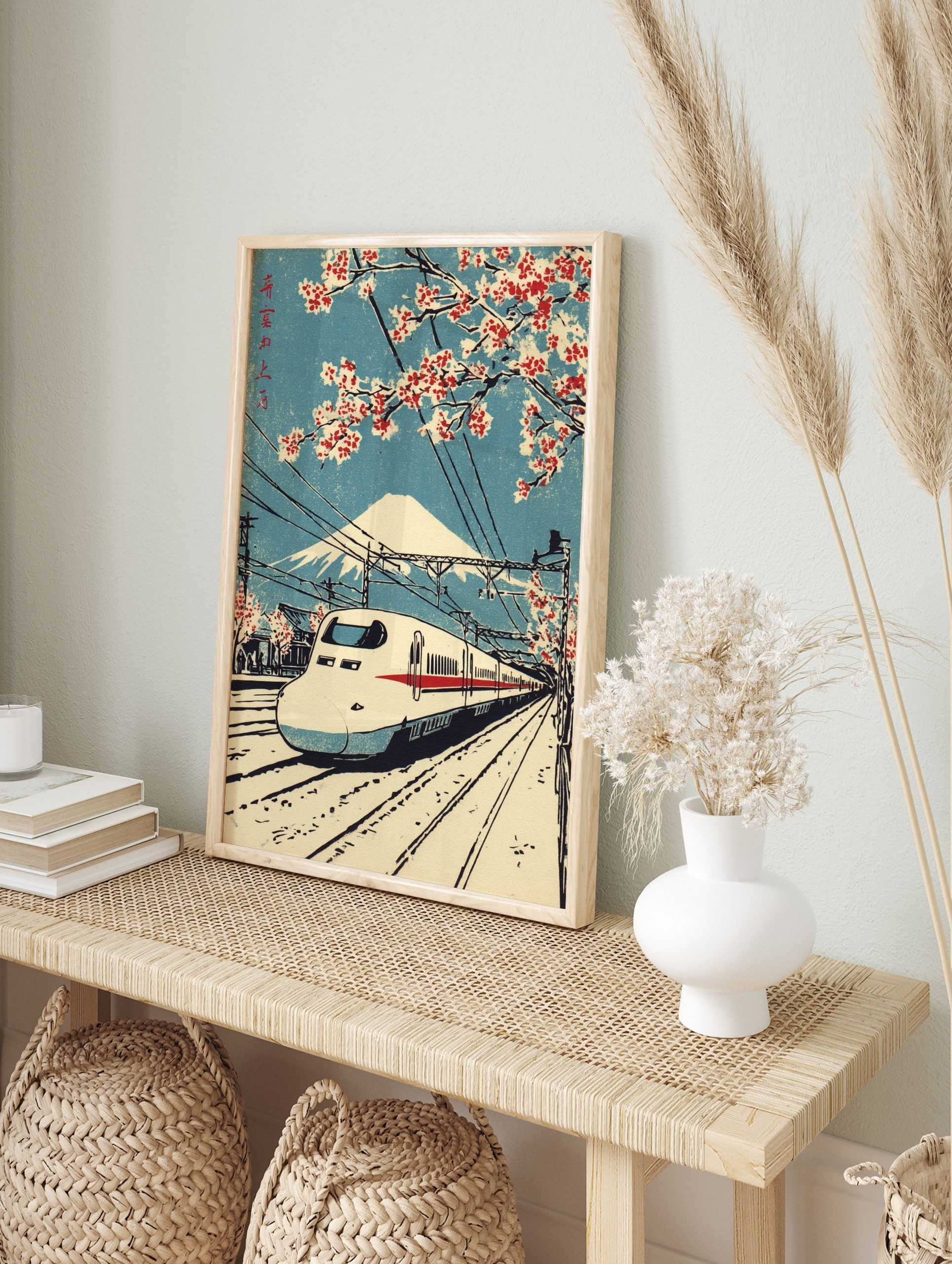 Japanese woodblock print of Shinkansen bullet train, Mount Fuji, and red cherry blossoms, in an alternate framed mockup