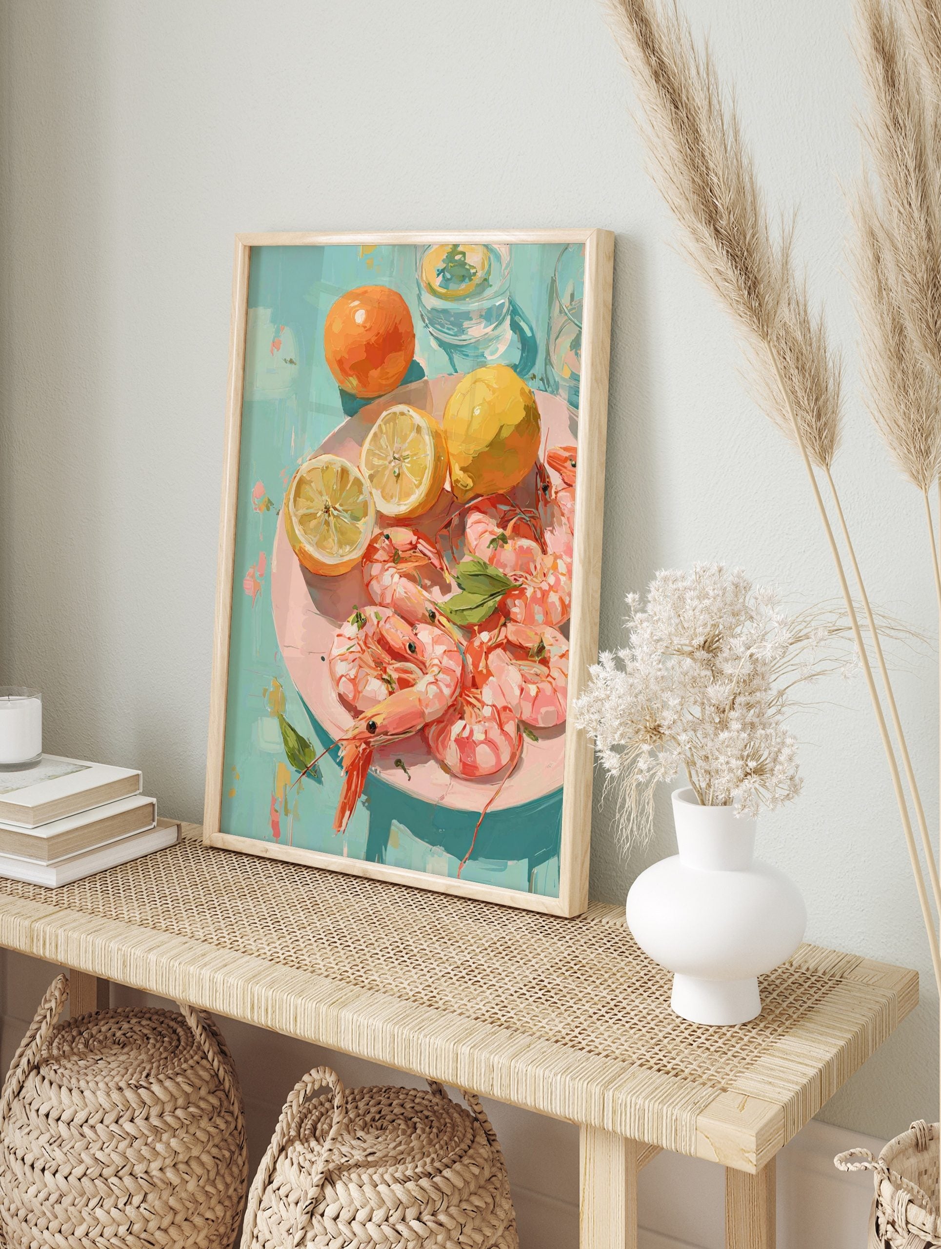 Illustrative print of pink shrimp, yellow lemons, and orange fruits on a pink plate against a, in an alternate framed mockup