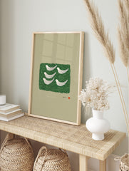 Six white stylised birds on a dark green wavy pattern, with Japanese text and red seal, on a, in an alternate framed mockup