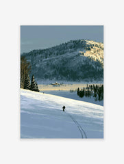 Illustrative art print of a lone skier on a vast snow-covered mountain landscape with blue and golden tones