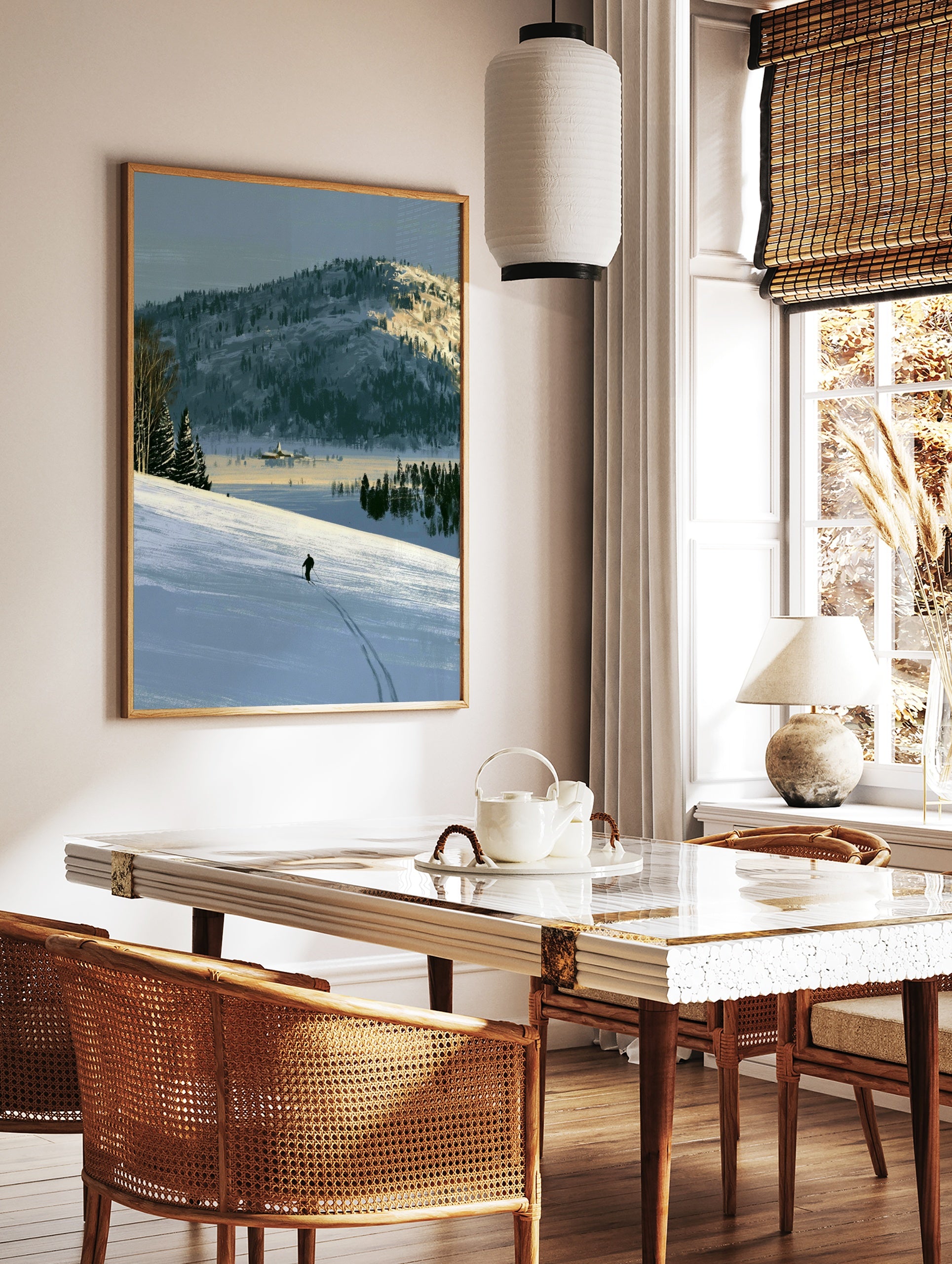 Illustrative art print of a lone skier on a vast snow-covered mountain landscape with blue and, in a styled room mockup